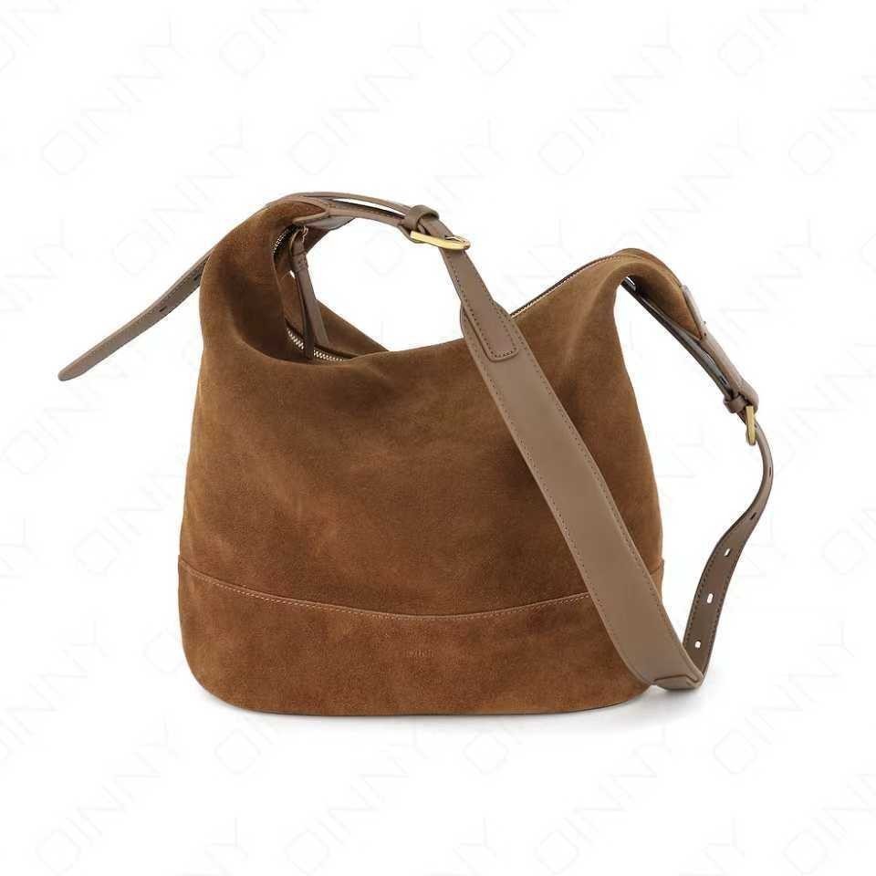 Brown suede handbag with a shoulder strap on a white background
