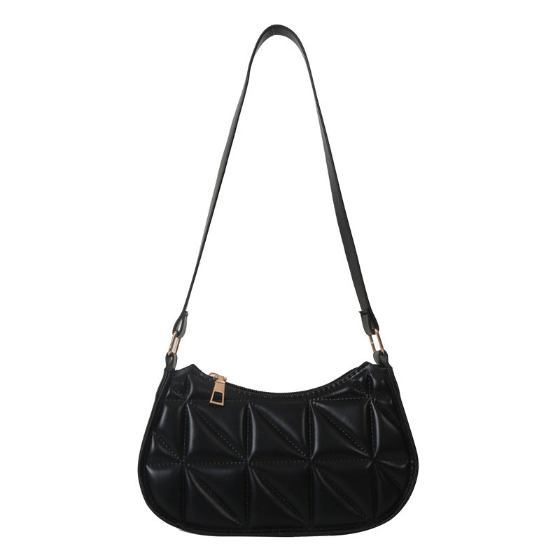 Black quilted handbag with a strap on a white background