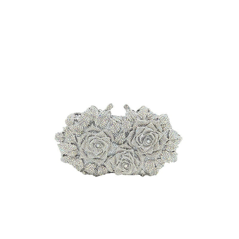 Silver clutch with rose design on a white background