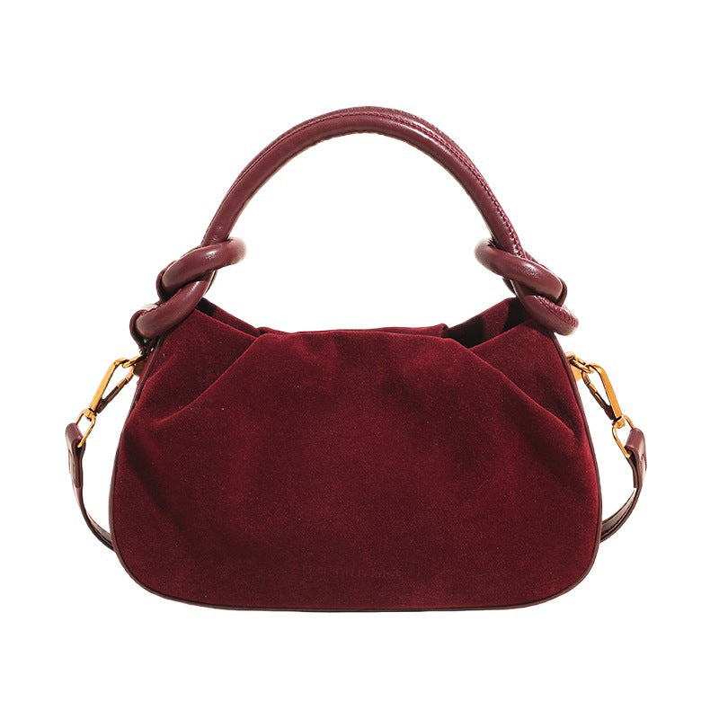 Red handbag with gold accents on a white background